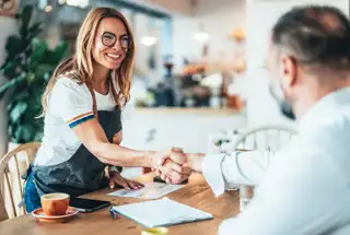 Handshake with a client after securing a franchise loan