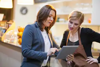 Two women discussing franchise financing loans
